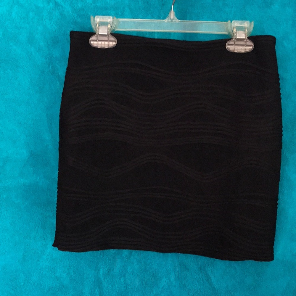 Black skirt with tactile wavy detail on fabric